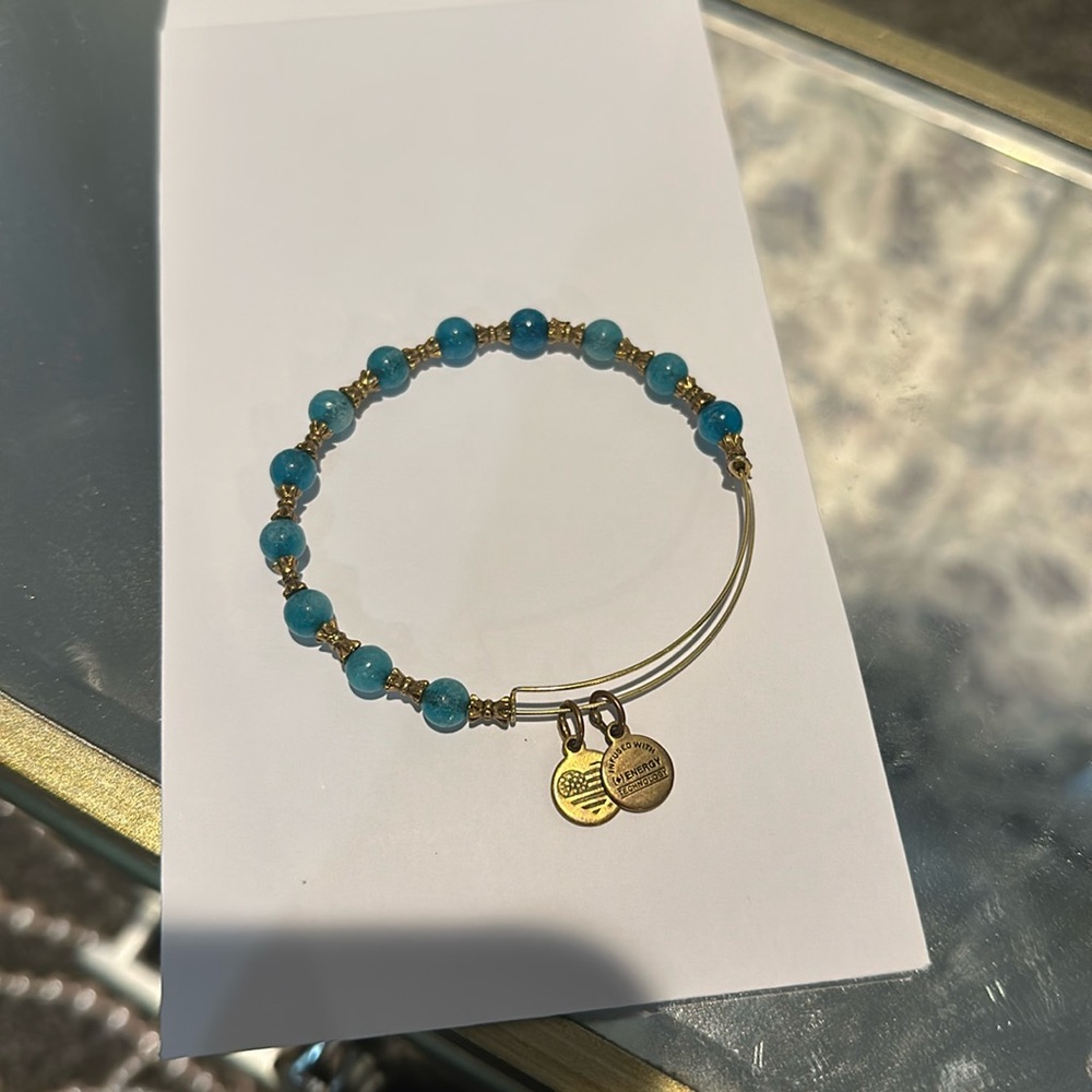 Women’s gold and blue bead Alex and Ani charm bracelet